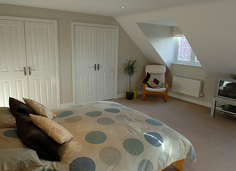 Loft conversion bedroom with dormer windows
